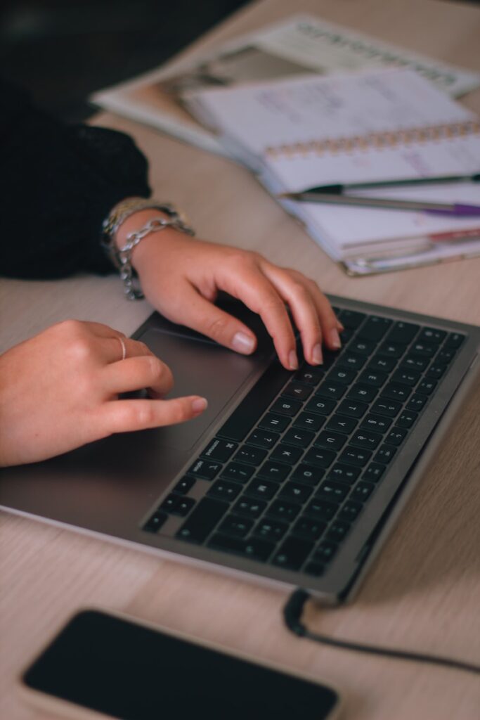 Photo by Swello a person typing on a laptop on a desk